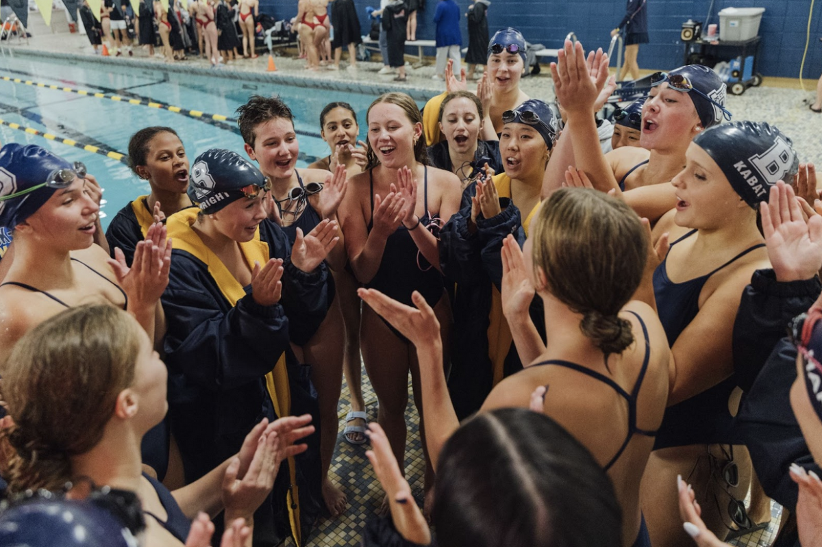 Swimmers celebrate during a 2025 home meet. Credit: Breck Photoshelter Galleries.
