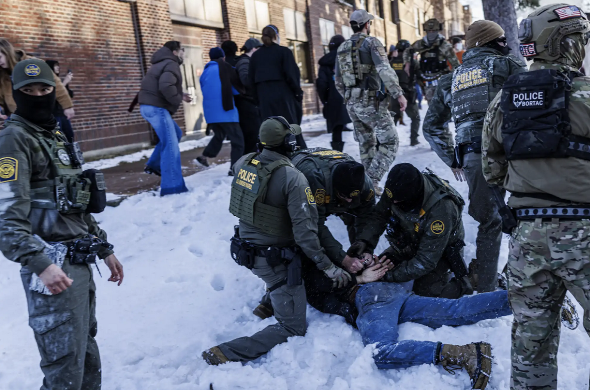 U.S. Border Patrol agents detain a person on the ground near Roosevelt High School during dismissal time on January 7th, 2026. Image from MPR News.